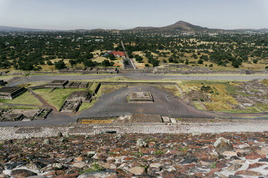View of the ancient archaeological site of Teotihuacan featuring the Avenue of the Dead, stone structures, and surrounding landscape in Teotihuacan de Arista, Estado de Mexico, Mexico.