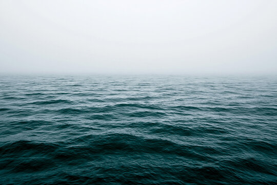 An expansive view of a greenish blue sea with a textured surface of gentle ripples.