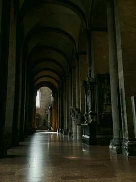 View of the interior of Basel Minster featuring stone columns, vaulted arches, and polished floors in Basel, Basel City, Switzerland.