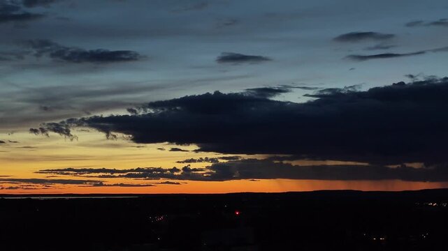 sunset gradient blue orange dusk with storm clouds and pouring rain dramatic sky footage