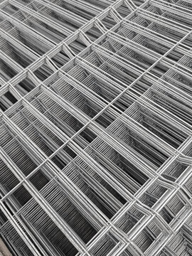 a stack of galvanized welded wire fence panels