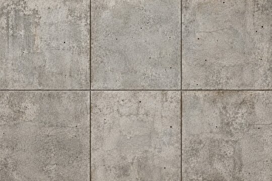 Weathered industrial gray concrete tile texture and cement block wall background for interior design architectural surfaces