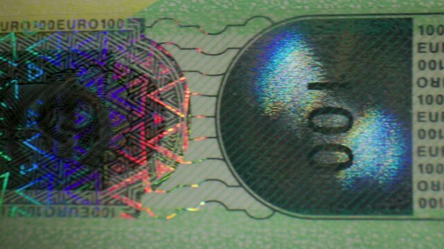 Extreme macro close-up of the holographic security feature on a 100 Euro banknote