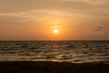 Fototapeta premium harmonic background of scenic sunset with bright sun at the ocean
