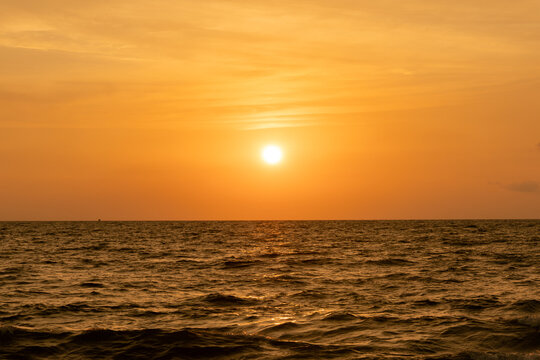 harmonic background of scenic sunset with bright sun at the ocean