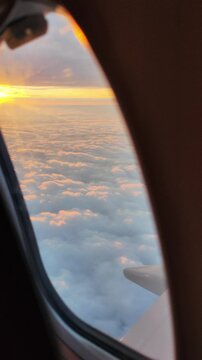 sunset sky dusk  above sea of clouds view from airplane window vertical footage
