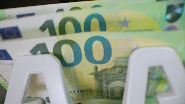 Extreme macro shot of 100 Euro banknotes in a rapid cash counting machine