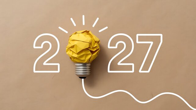 Creative 2027 concept featuring a crumpled yellow paper lightbulb on a smooth beige background, representing innovation and, future planning