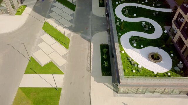 Aerial View of Modern Residential Courtyard with Contemporary Landscape Design, Green Roof Garden, and Geometric Paving