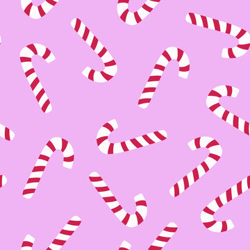 Candy canes in a repeating pattern against a soft pink background for holiday celebrations and festive designs