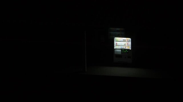 Illuminated vending machine glowing in the dark at station, Hakodate, Japan, 2026.09.10.