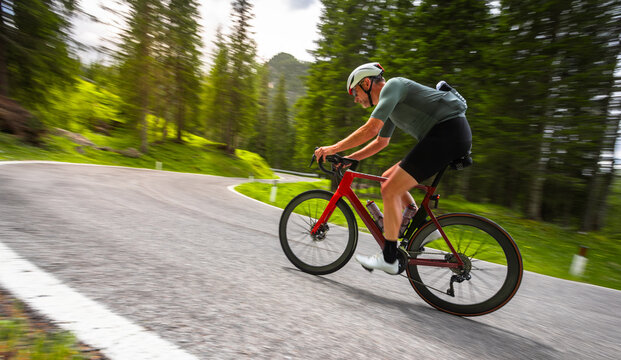 Road Cyclist Riding on Mountain Road in Italian Dolomites