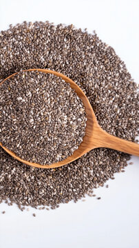 Chia seed pile with wooden spoon on white background, healthy superfood rich in nutrients