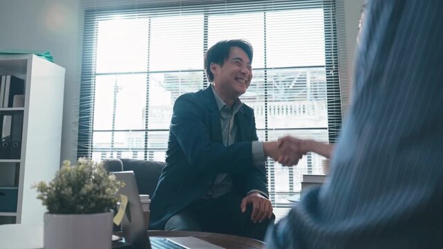 Businessman Handshaking with Client After Successful Business Deal