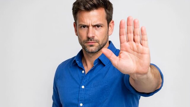 Man holds hand up, stopping gesture