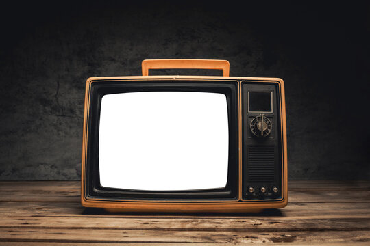 Front view, still life retro old TV with white screen on wood table in dark room, cut out screen
