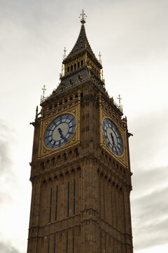 the Elizabeth Tower housing Big Ben in London, showcasing its grand Gothic architecture, prominent clock faces with ornate golden frames
