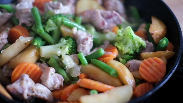 Cooking Meat and Mixed Vegetables in a Frying Pan 4K