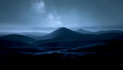 Fototapeta premium A panoramic view of a vast mountain landscape under a cloudy sky during nighttime showcasing the natural beauty and serenity of remote wilderness areas for travel and nature enthusiasts