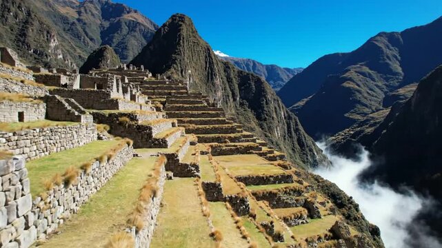 Scenic View of Ancient Machu Picchu Inca Ruins in the Peruvian Andes Mountains with Terraced Landscapes and a Clear Blue Sky