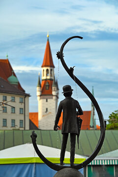 Karl Valentin Brunnen Fountain at Viktualienmarkt with Old Town Hall Tower in Munich Germany