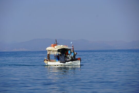 A fishing boat returning in the morning, in Glyfada, Greece