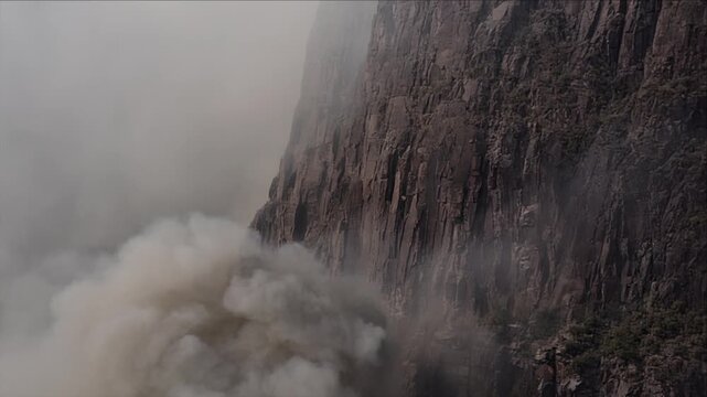 Misty Mountain Cliff Rockfall in Dense Fog and Rain, Cinematic Climate Disaster Geology Concept with Dramatic Canyon Rock Texture and Atmospheric Wilderness Storytelling Scene