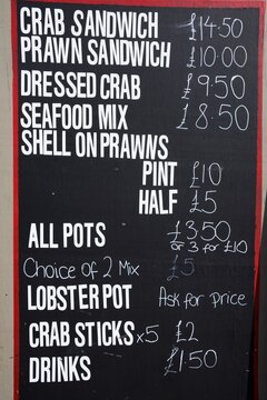 Seafood menu chalk board along the waterfront, West Bay, Dorset, UK, Europe