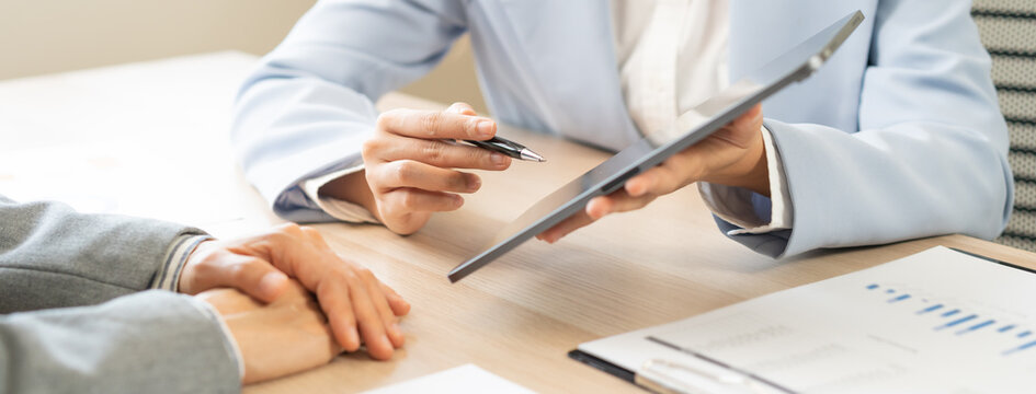 Business meeting, asian group brainstorm analysis on graph data of cost plan. financial consult planning investor asses and present to client, client and advisor review investment strategy in office.
