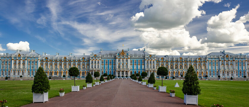 Ultra-wide panoramic view of Catherine Palace with formal gardens and expansive dramatic sky in the Tsarskoye Selo Museum Reserve, Pushkin, Saint Petersburg, Russia