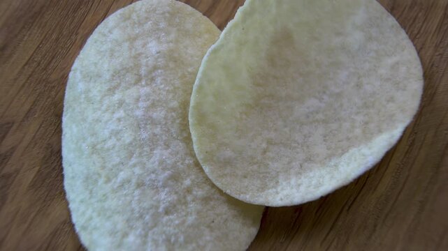 Two Curved Potato Crisps Showing Shape and Surface Structure