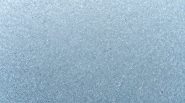 Closeup of soft blue fleece fabric texture with fine fibers and a subtle, uniform pattern