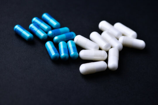 Amino acids and creatine capsules.Nutrition for bodybuilding. Fitness supplements on paper background. Soft focus. Close up