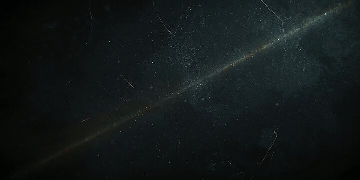 Dark cinematic film grain texture with dust particles and light scratches for vintage video overlay effect
