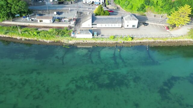 High Angle Footage of Beach and Ocean of Looe Town at River and Beach During Hot Sunny Day June 29th, 2025. Looe is a coastal town and civil parish in southeast Cornwall, England, United Kingdom.