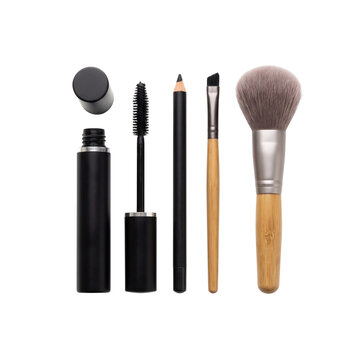 A collection of essential makeup tools, including mascara, eyeliner pencil, a makeup brush, and a powder brush, are neatly arranged for a perfect application.