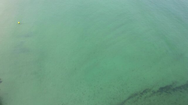 High Angle Footage of Beach and Ocean of Looe Town at River and Beach During Hot Sunny Day June 29th, 2025. Looe is a coastal town and civil parish in southeast Cornwall, England, United Kingdom.