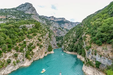 Tourists enjoying turquoise waters of the Verdon River in France, paddling pedal boats and kayaks on a sunny day © rudiernst