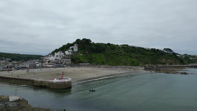 High Angle Footage of Beach and Ocean of Looe Town at River and Beach During Hot Sunny Day June 29th, 2025. Looe is a coastal town and civil parish in southeast Cornwall, England, United Kingdom.