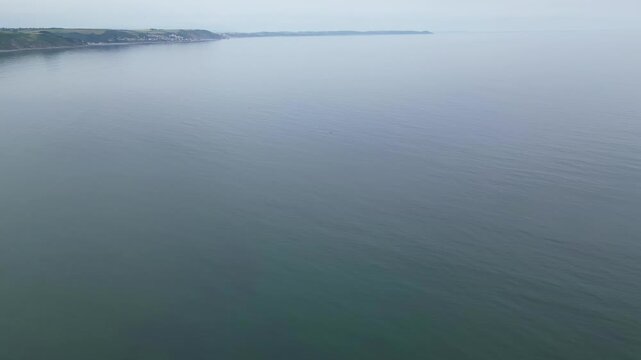 High Angle Footage of Beach and Ocean of Looe Town at River and Beach During Hot Sunny Day June 29th, 2025. Looe is a coastal town and civil parish in southeast Cornwall, England, United Kingdom.