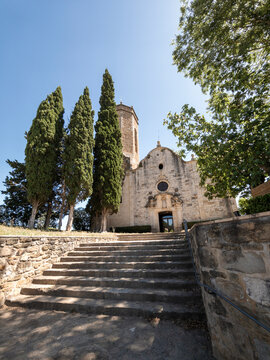 Sant crist&ograve;fol de cunit church with cypress trees and stone stairs
