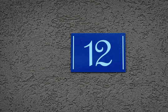 House number 12 on the gray wall