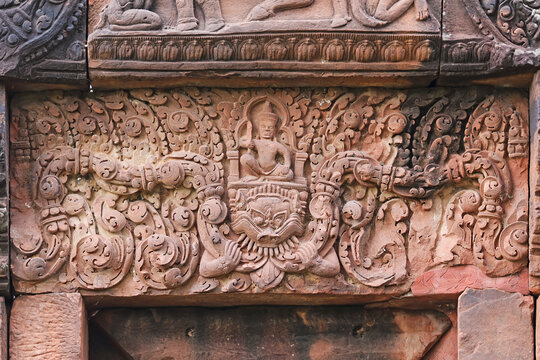 Intricate sandstone lintel carving depicting Hindu god above Kala face at the library building of Prasat Peuai Noi, Khon Kaen, Thailand