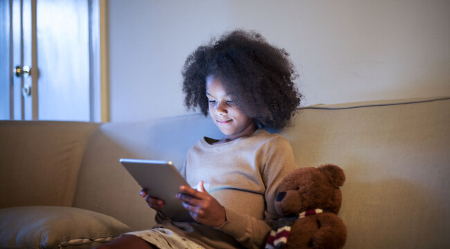 Young African kid using digital tablet