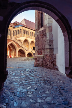 Arched passage framing the inner courtyard and staircase at Corvin Castle in Hunedoara Romania