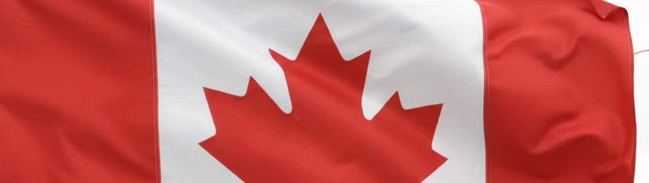 National identity and patriotism concept Canadian flag waving in the wind slow motion close up of red and white maple leaf banner.