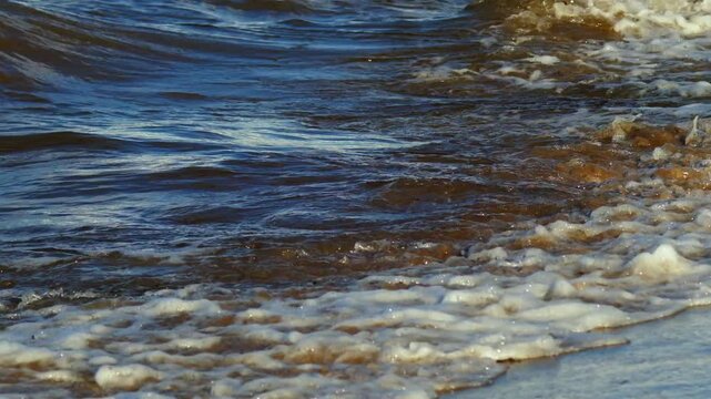 Close Up of Ocean Wave Crashing and Splashing on Sandy Beach - Refreshing Sea Surf and White Foam Washing Over Wet Sand