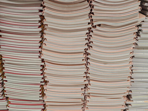 Pile of school notebooks on shelf