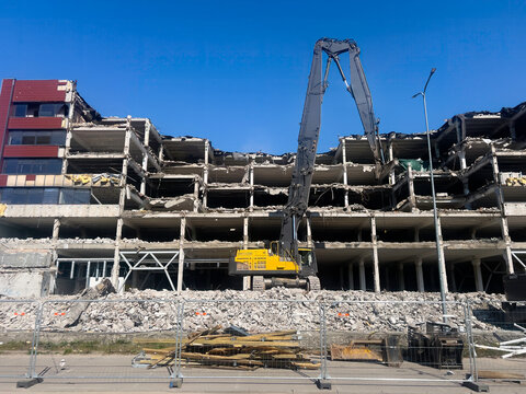 Crane is demolishing an old concrete building. Riga Latvia