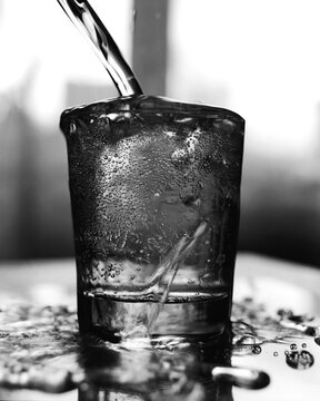 Overflowing Glass of Sparkling Water in Black and White